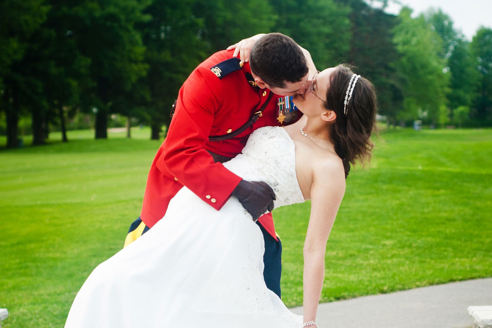 Groom in RCMP uniforming kissing Bride | Rivermead Golf Club | Hannah Martin Photography