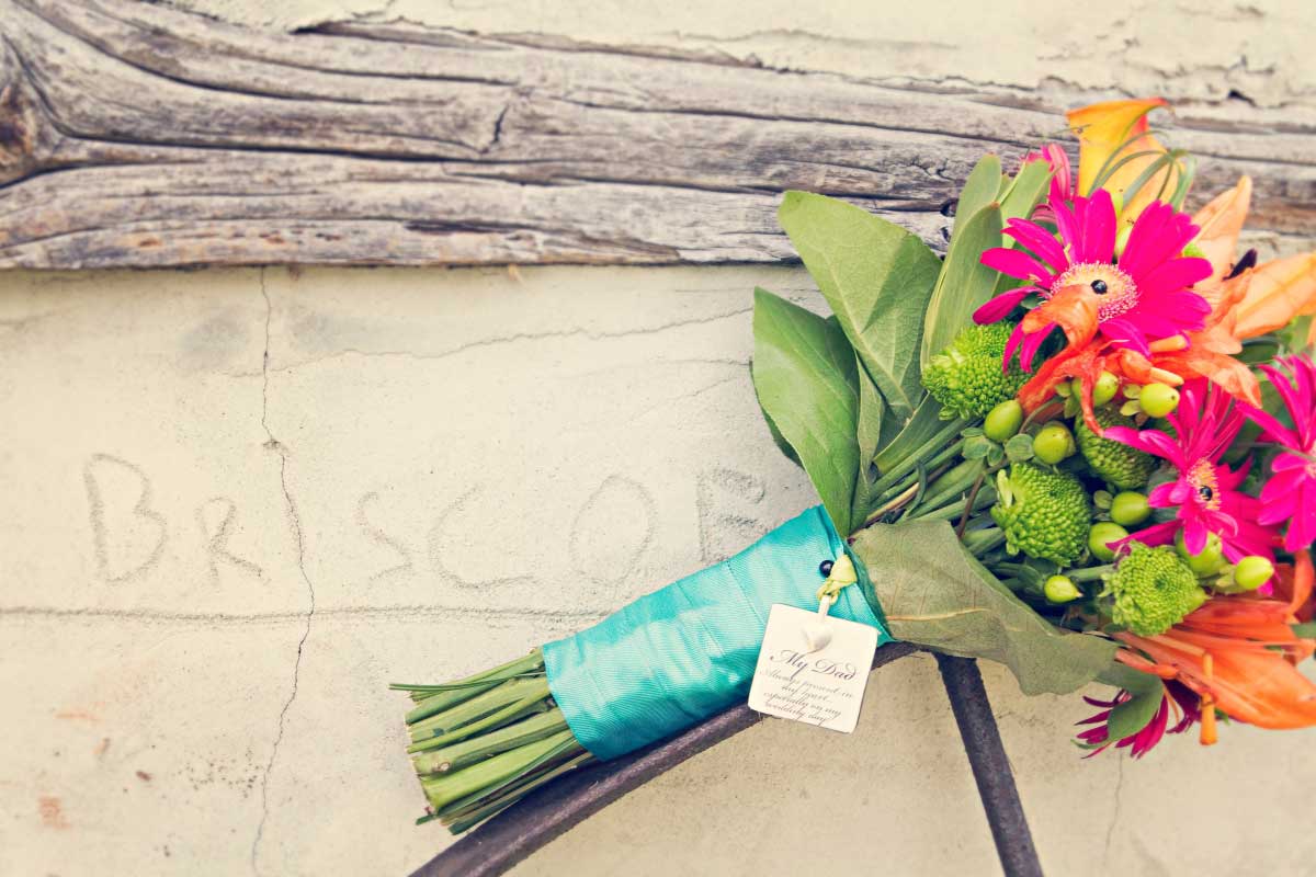 Pink orange green wedding bouquet with memorial locket | Renaissance Studios