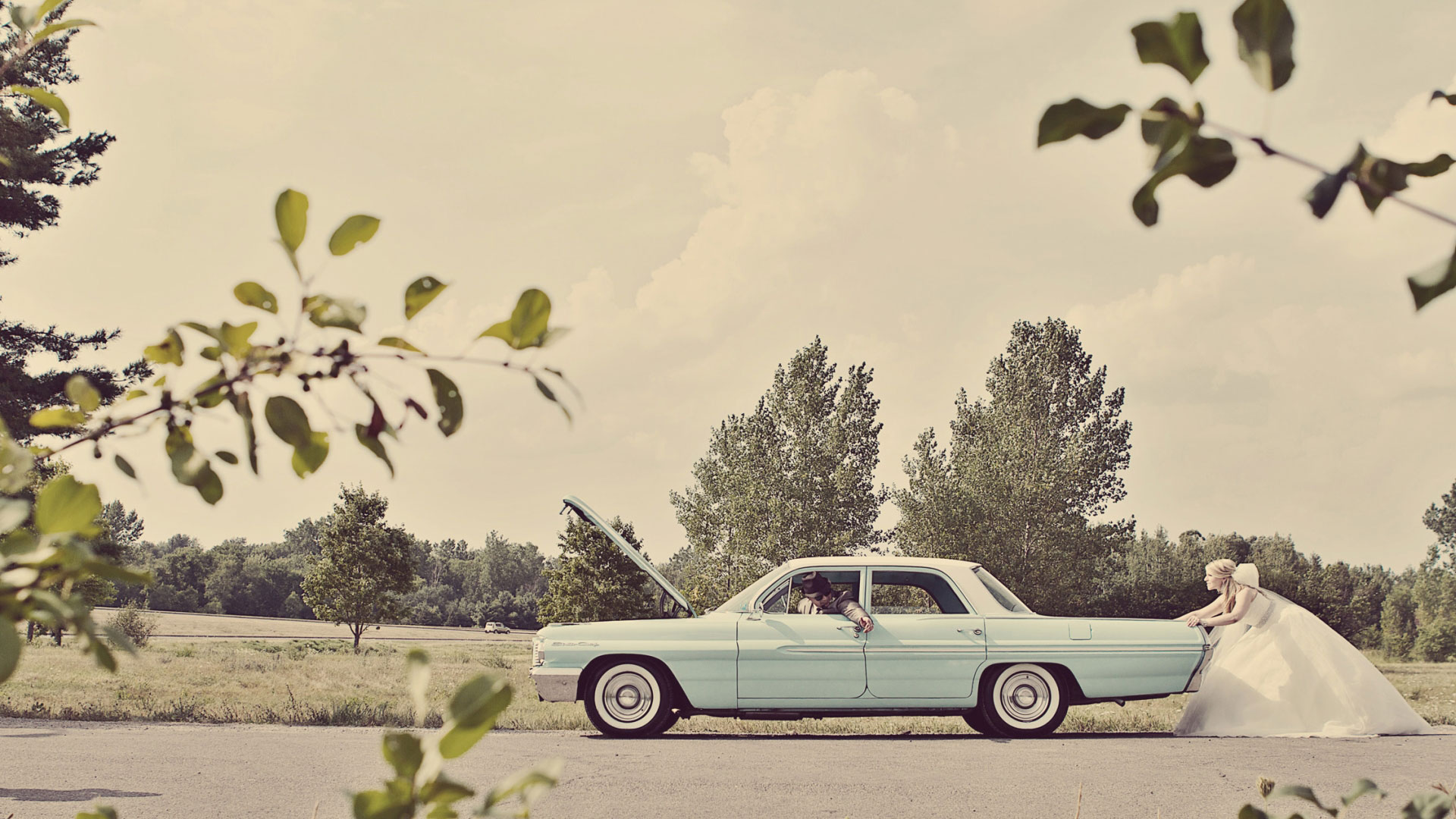 Bride pushing groom in blue vintage car | Sala San Marco | Renaissance Studios