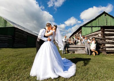 Couple kissing bridal party barn wedding | Stonefields Heritage Farm| Themotions Photography