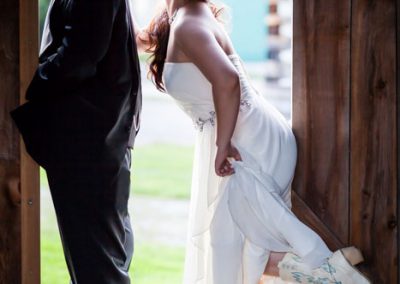 Bride and groom rustic barn cowboy boots | Stonefields Heritage Farm | Themotions Photography